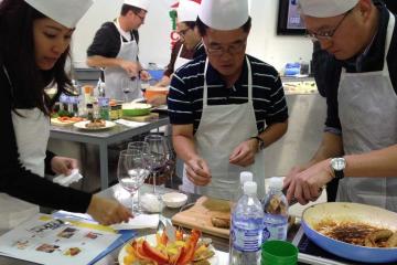 team collaborate to complete cooking team building activity sausage sensation culinary