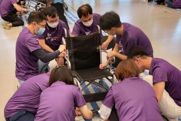 Team of people building a wheelchair