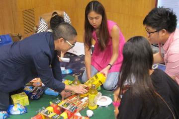 team collaborate to complete challenging team building game snacks