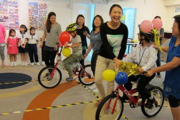 smiling women give newly built bikes to happy children macau