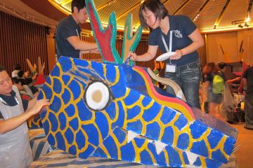 two people paint the dragon in team building activity dragon squad