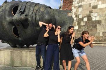 posing in front of a statue