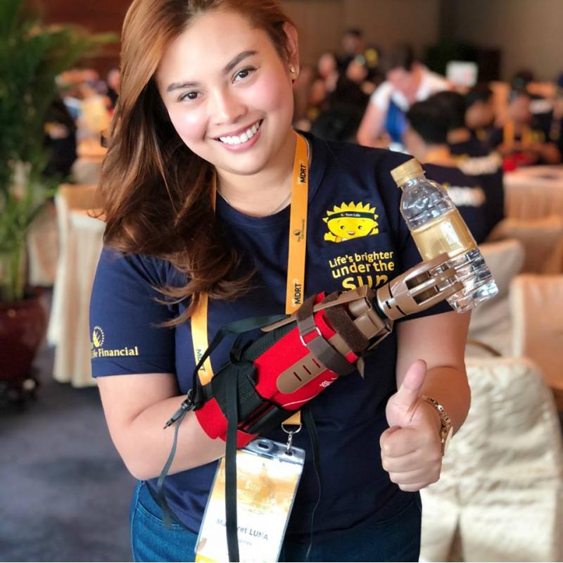 Sun Life Girl holding water bottle with prosthetic hand