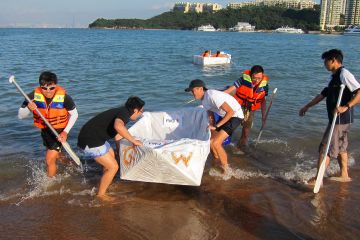 team collaborate to put race boat in the water