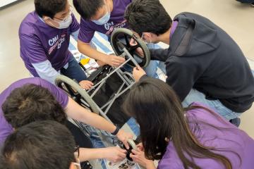 Team of people building a wheelchair